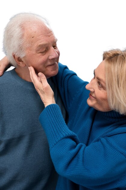 studio portrait of loving elderly couple