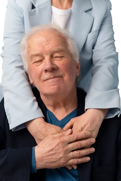 studio portrait of loving elderly couple