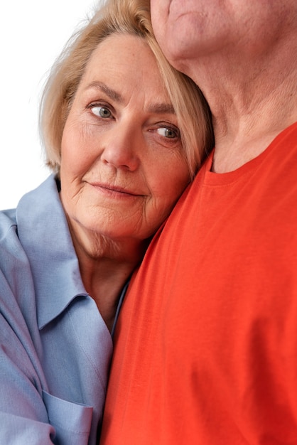 Studio portrait of loving elderly couple