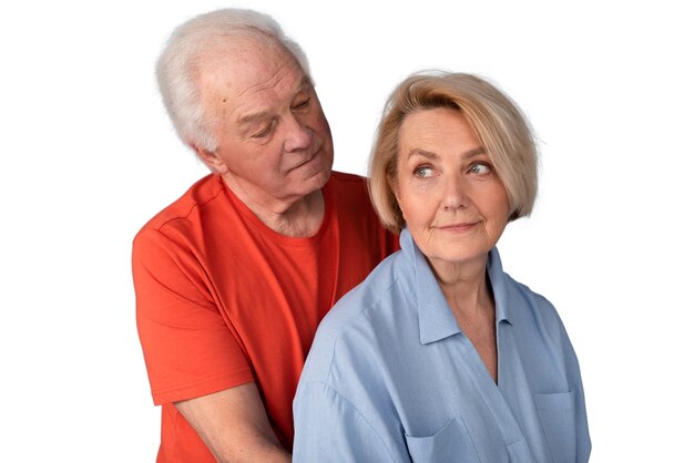 Studio portrait of loving elderly couple