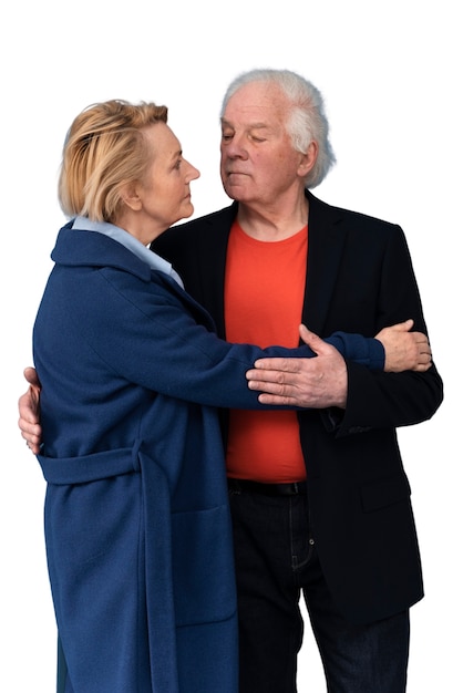 Studio portrait of loving elderly couple