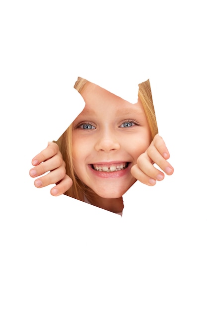 Free PSD studio portrait of young girl coming out of paper cut-out