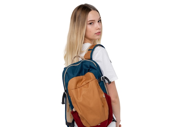 Studio portrait of young teenage student girl with backpack