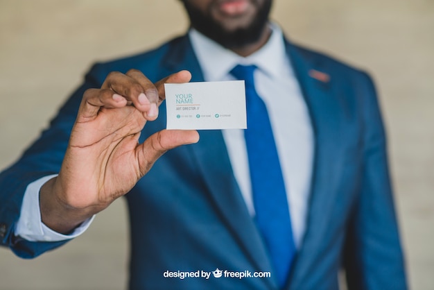 Stylish businessman showing business card