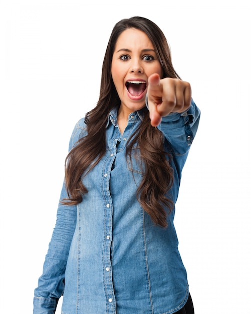 Teenager with open mouth pointing at you