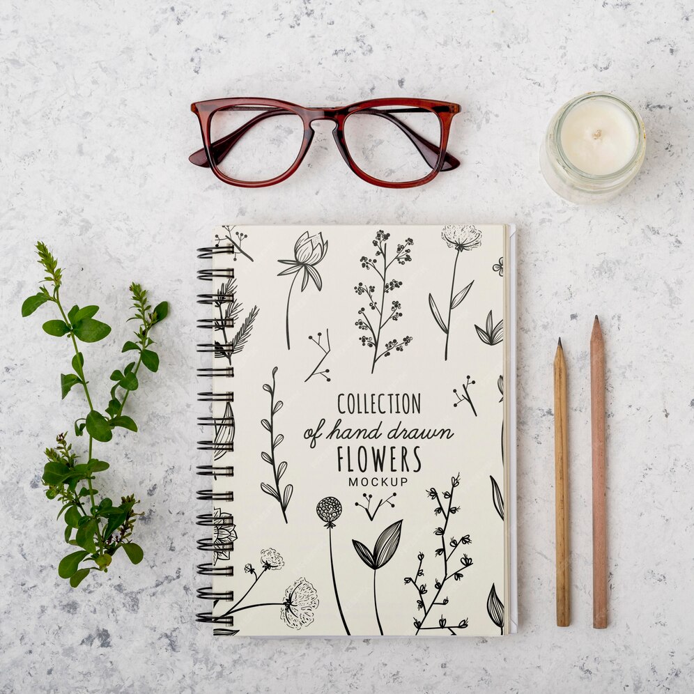 Free PSD | Top view eyeglasses and notepad with mock-up