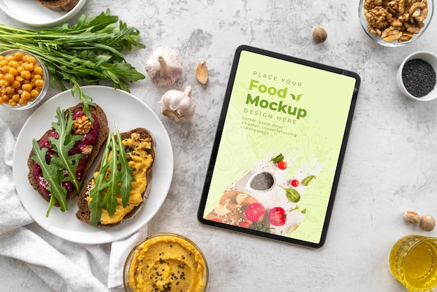 Top view ingredients and food with tablet mock-up