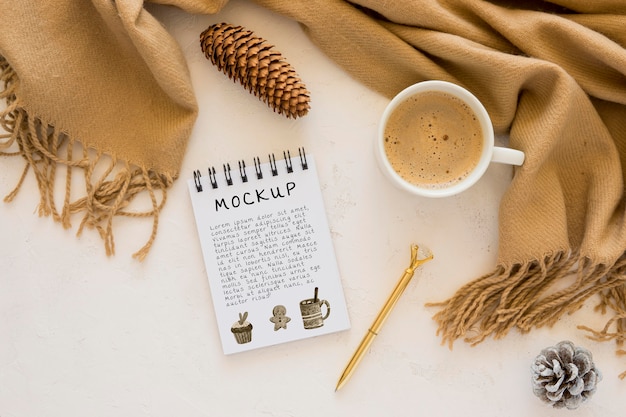 Top view of notebook with coffee and scarf