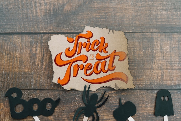 Torn paper mockup with halloween concept and elements on bottom Free Psd