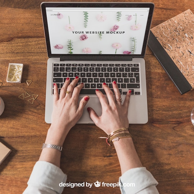 Typing hands on laptop