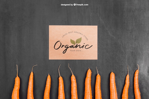 Free PSD vegetables mockup with cardboard and carrots