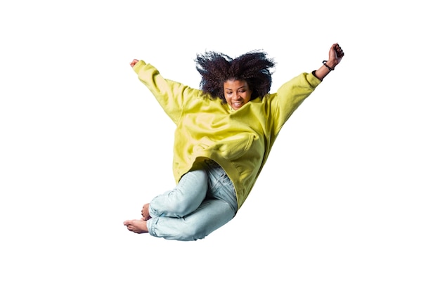 View of happy woman jumping in mid-air