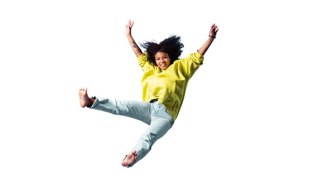 View of happy woman jumping in mid-air