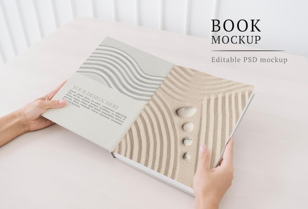 Wellness book mockup psd with zen sand and stones on the pages