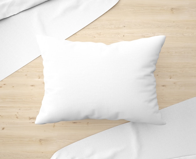 White pillow with bedsheets on the floor