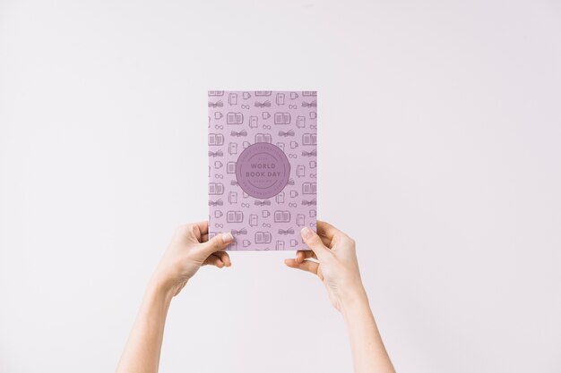 Woman holding book cover mockup