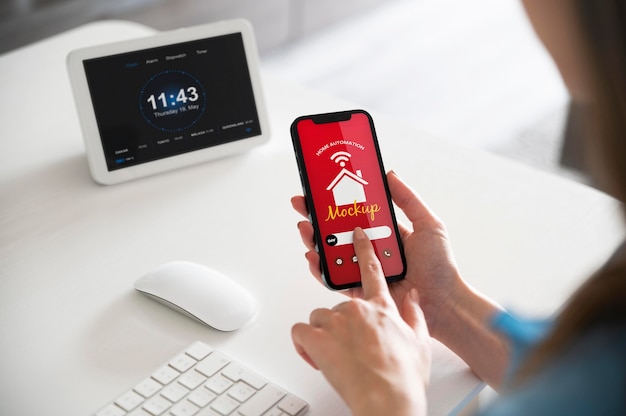 Woman holding a smartphone with a home automation app