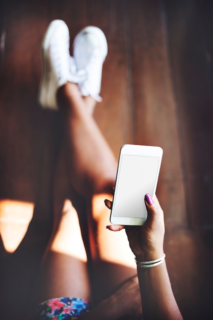 Free PSD woman using a smartphone with an empty screen