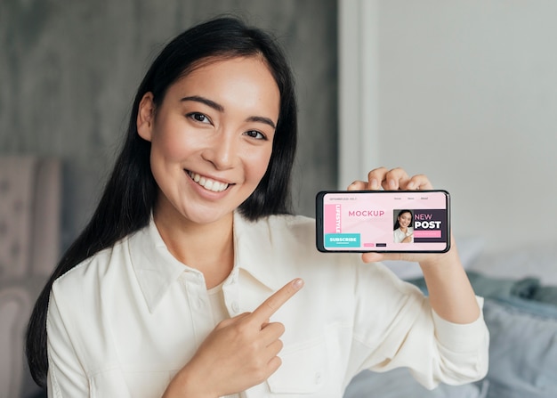 Woman vlogger holding a phone mock-up