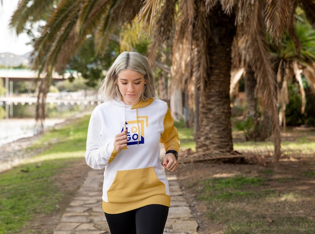 Woman wearing hoodie running