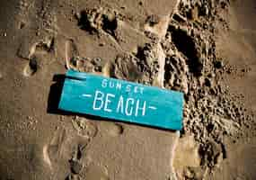 Free PSD wooden sign on the sand