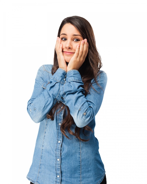 Worried young woman with hands on face