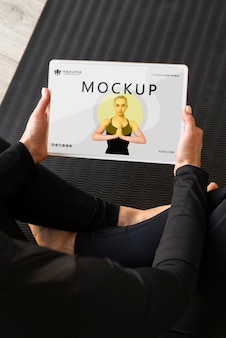 Yoga instructor holding a tablet mock-up