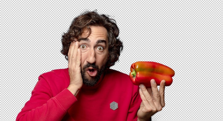 Free PSD young adult bearded man with a red pepper