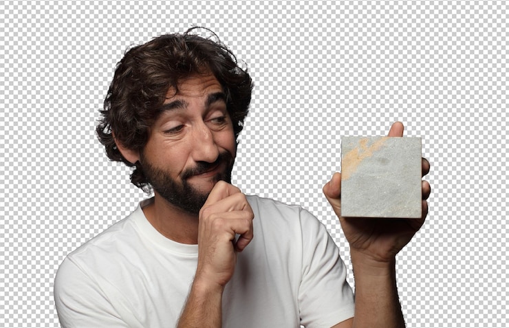 Free PSD young adult bearded man with a stone brick