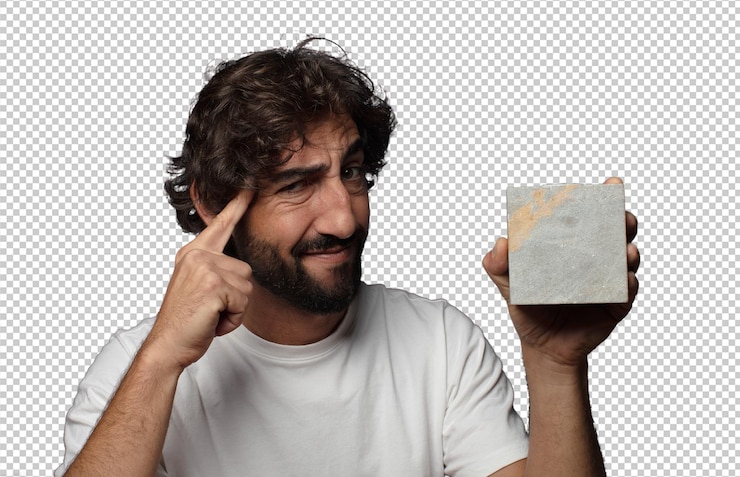 Free PSD young adult bearded man with a stone brick