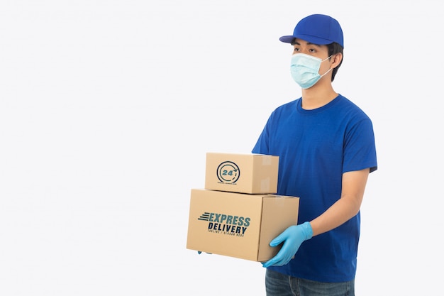 Young delivery man holding paper cardboard box mockup