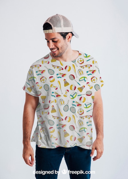 Young guy posing with colorful t-shirt and cap