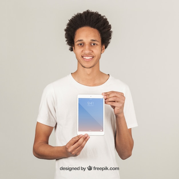 Young man showing tablet