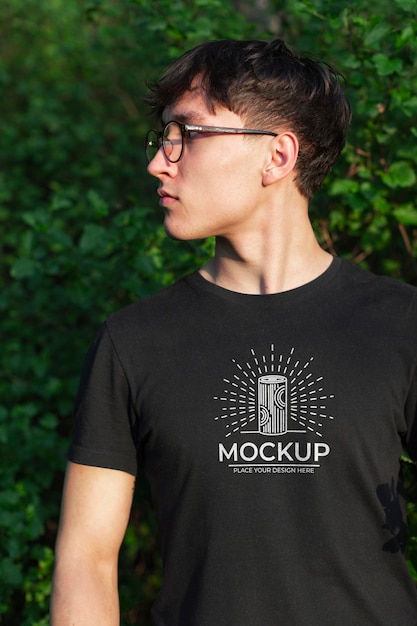 Young man wearing a mock-up t-shirt in the nature