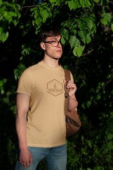 Young man wearing a mock-up t-shirt outdoors