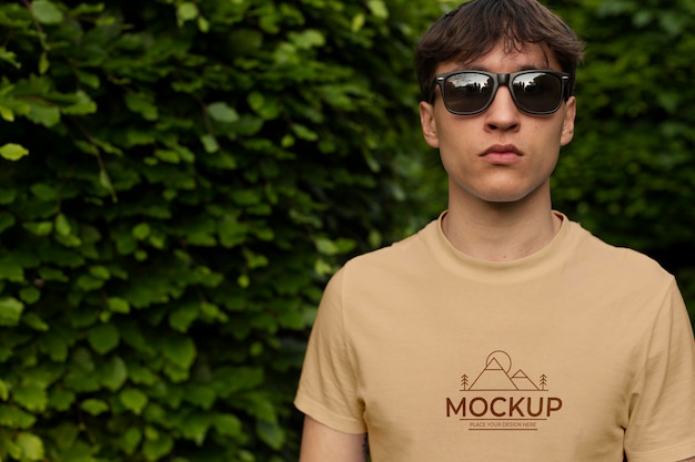 Young man wearing a mock-up t-shirt outside