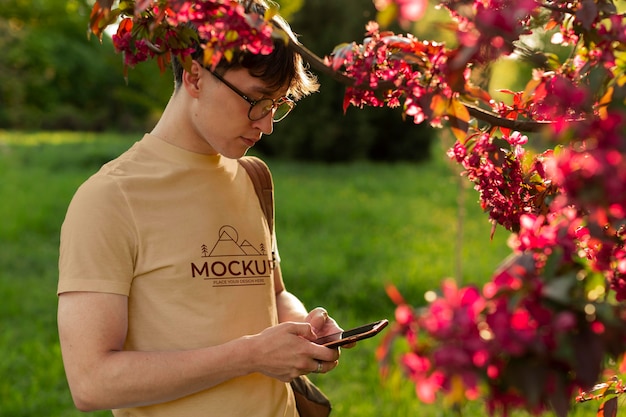 Young man wearing a mock-up t-shirt outside