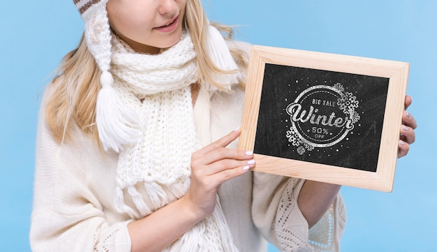 Young woman holding mock-up sign