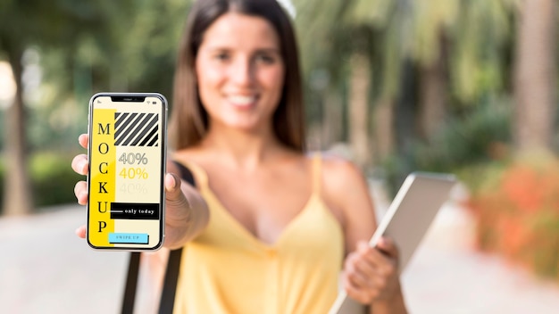 Young woman showing her phone mock-up