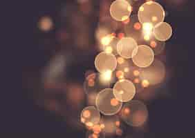 Free vector abstract background with golden bokeh lights