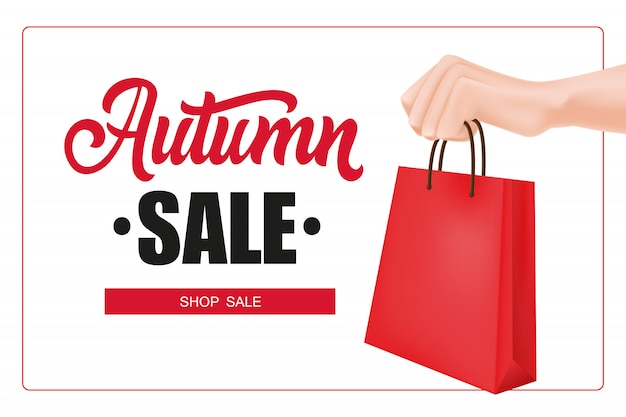 Autumn sale lettering in frame with hand holding shopping bag
