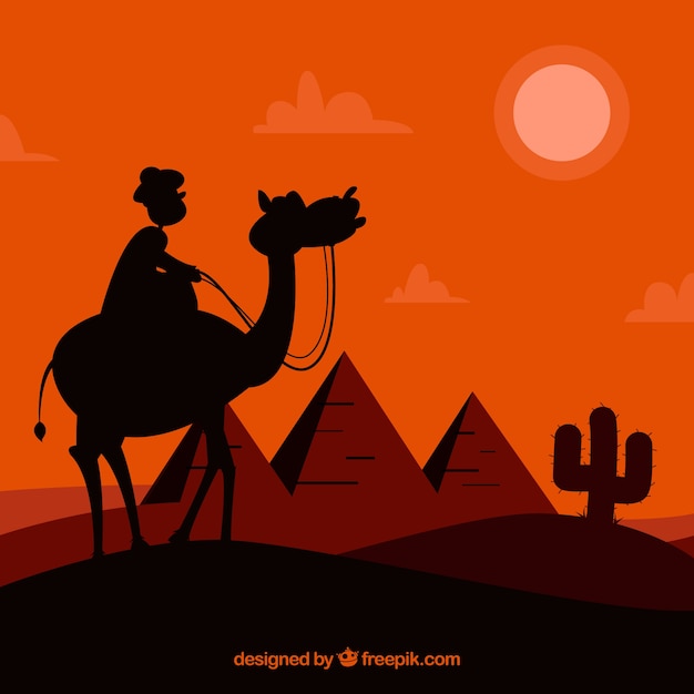 낙타의 캐러밴과 이집트 피라미드 풍경의 배경