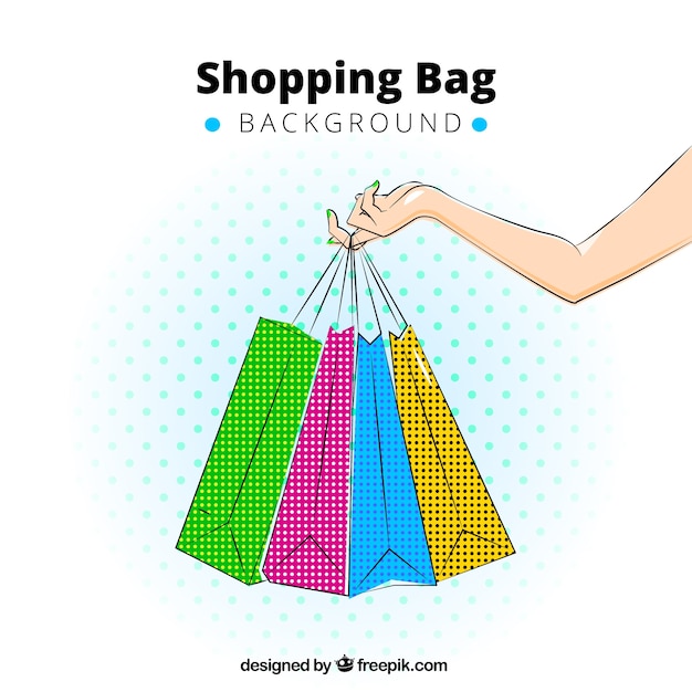 Background of hand holding colorful shopping bags