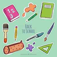 Free vector background with hand-drawn school supplies