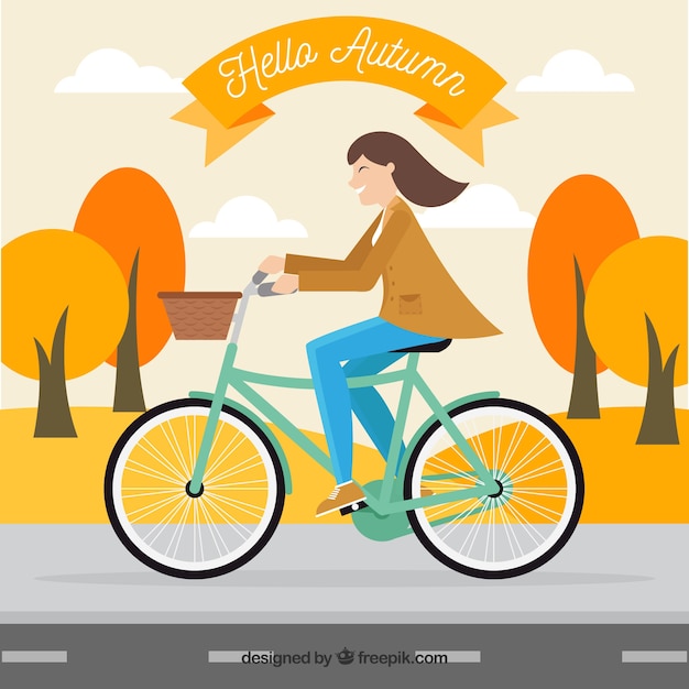 Background of woman on a bicycle in an autumnal landscape