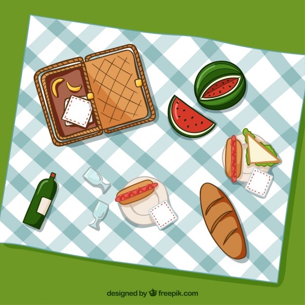 Basket with picnic elements and food in top view