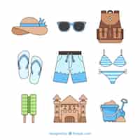 Free vector beach elements collection with clothes in hand drawn style
