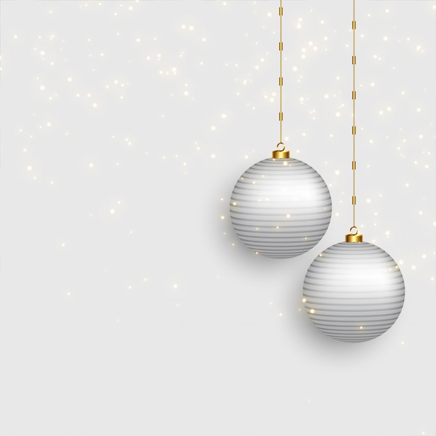 Free vector beautiful christmas balls on snowy background