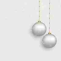 Free vector beautiful christmas balls on snowy background