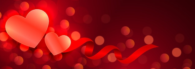 Free vector beautiful hearts glowing red bokeh banner